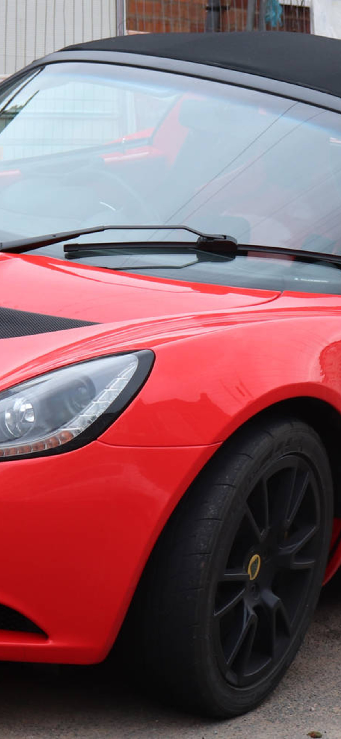 Red Lotus Elise Car Parked On Curb Mec Ultra HD iPhone 16 Wallpaper